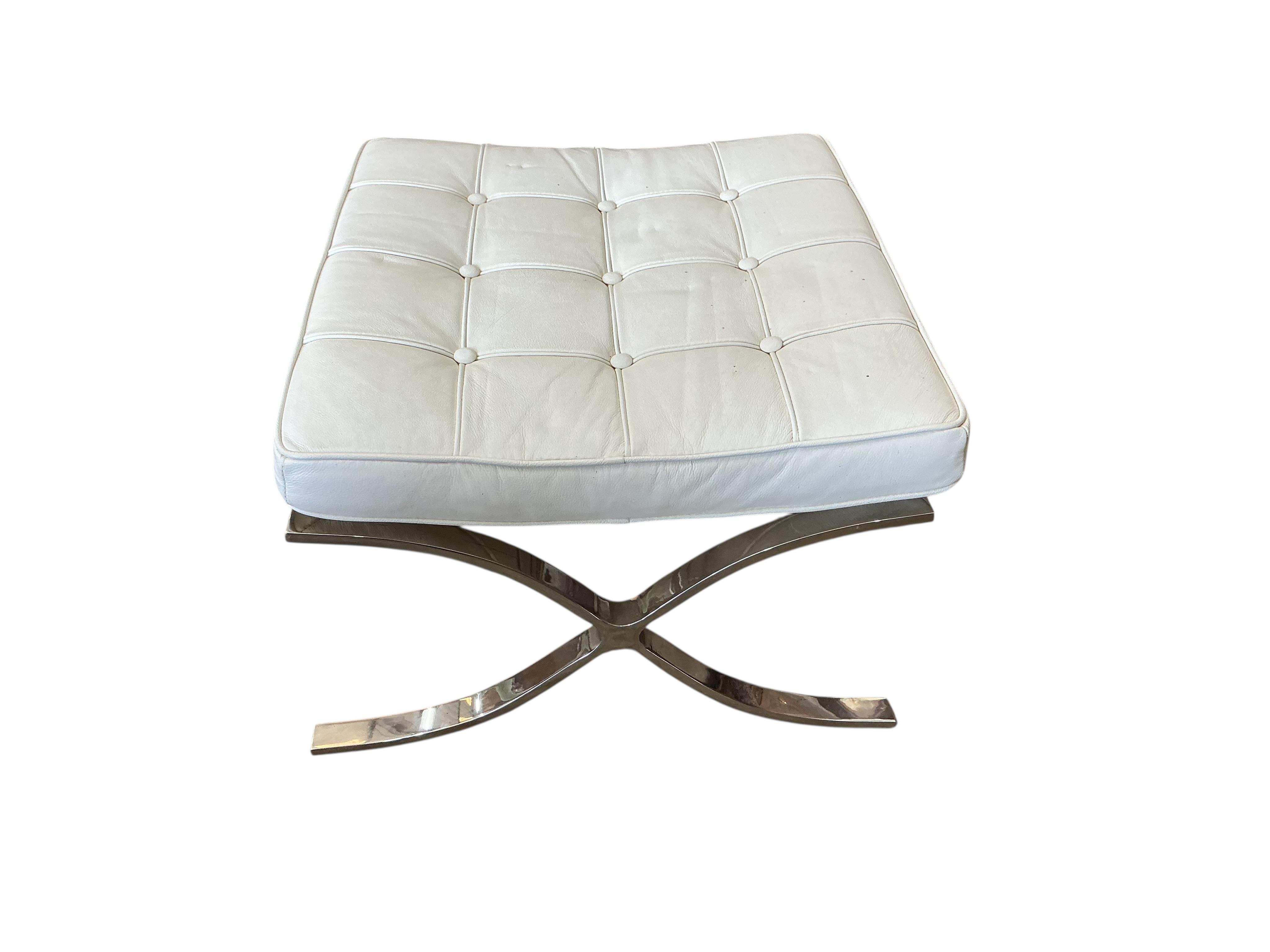 A 'Barcelona style' white leather chair, width 76cm, depth 70cm, height 74cm together with a footstool